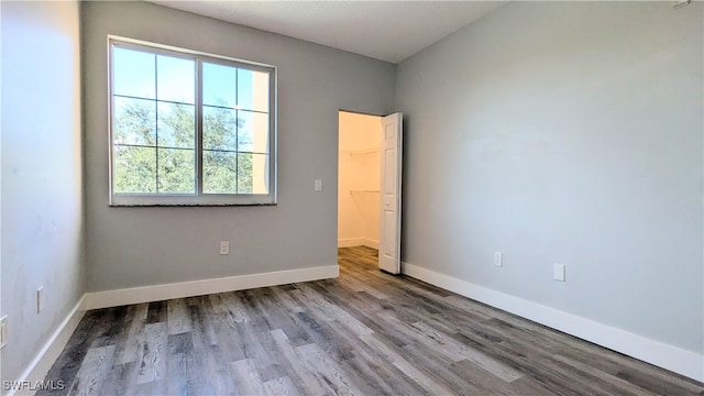 unfurnished room with hardwood / wood-style floors