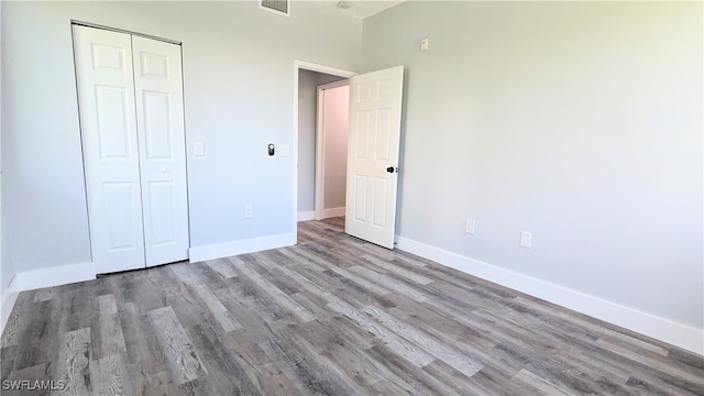 unfurnished bedroom with a closet and light wood-type flooring