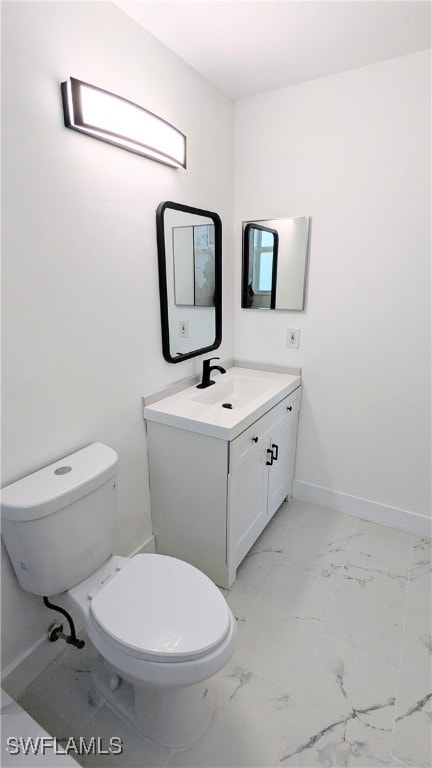 bathroom featuring toilet and vanity