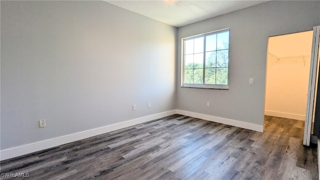 interior space with a textured ceiling and hardwood / wood-style flooring