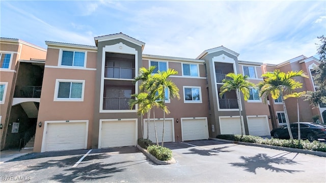 townhome / multi-family property featuring a garage and a balcony