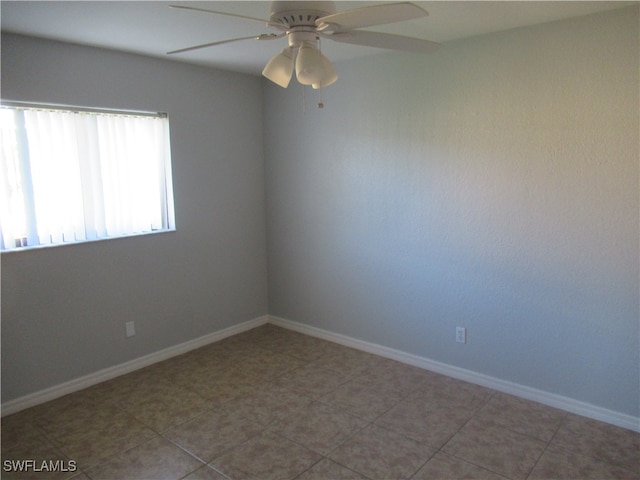 spare room featuring tile patterned flooring and ceiling fan