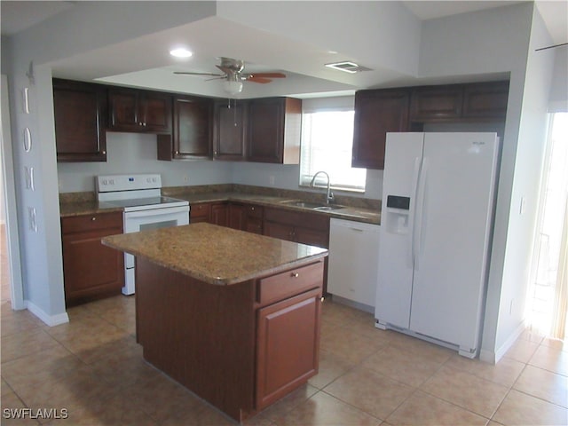 kitchen featuring ceiling fan, light tile patterned floors, sink, a center island, and white appliances