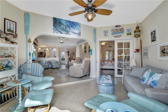 living room with french doors, ceiling fan, and a wealth of natural light