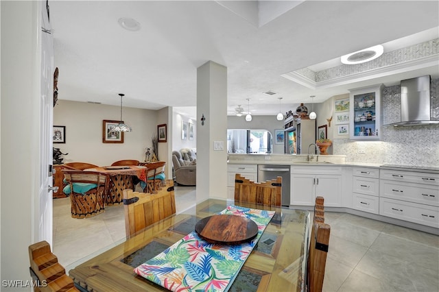 tiled dining area featuring sink and ceiling fan