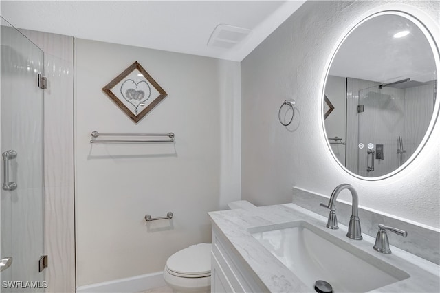 bathroom featuring toilet, an enclosed shower, and vanity