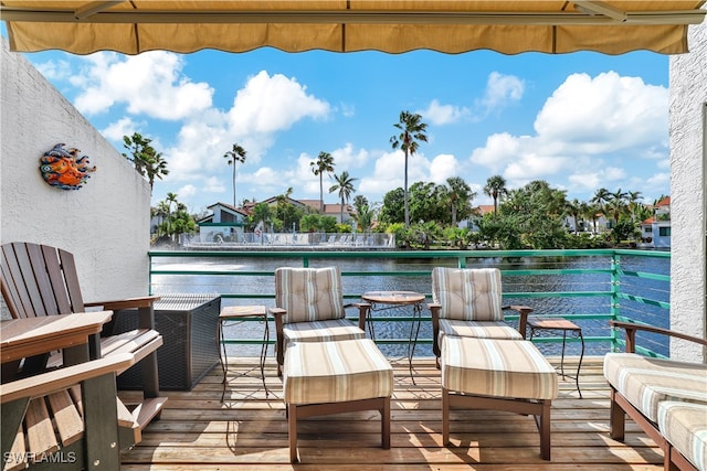 wooden terrace featuring a water view