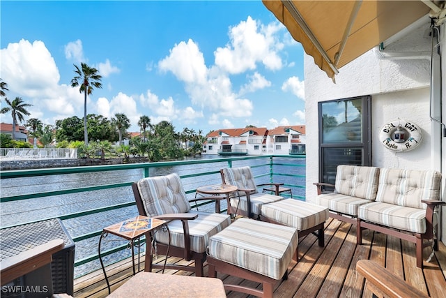 balcony featuring an outdoor living space and a water view