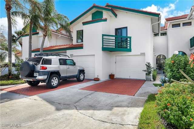 view of front of house featuring a garage and a balcony