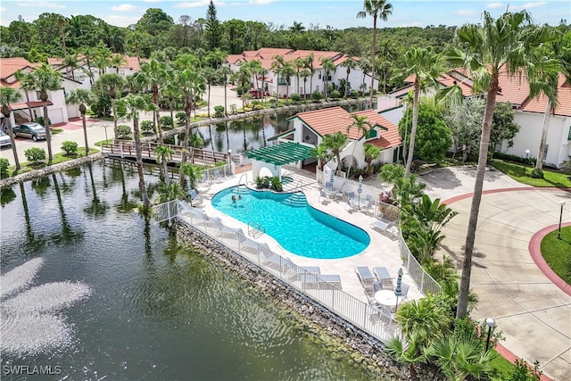 view of pool featuring a patio area and a water view