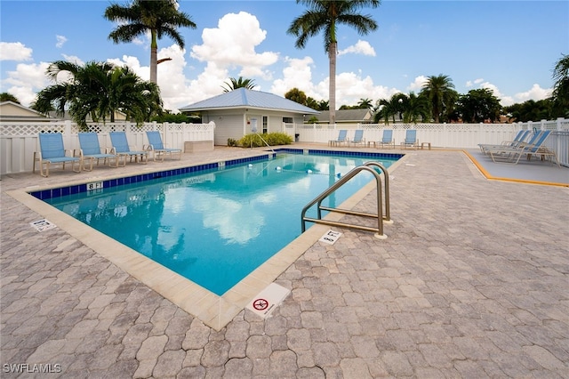 pool with fence and a patio