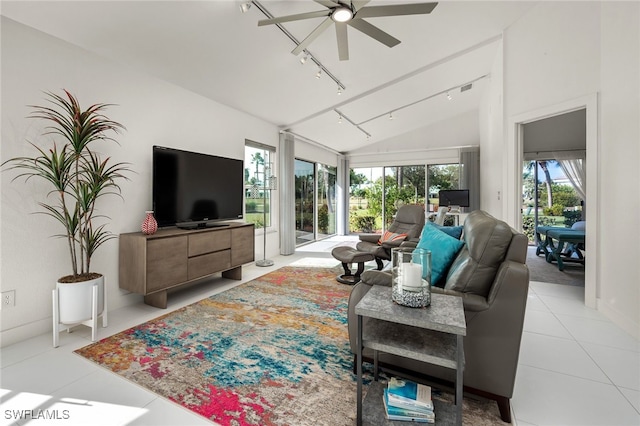 living room featuring lofted ceiling, ceiling fan, track lighting, and light tile patterned floors