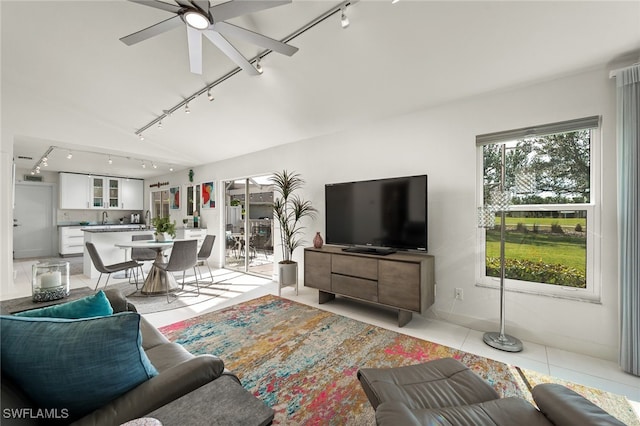 living room featuring light tile patterned floors, rail lighting, and a ceiling fan