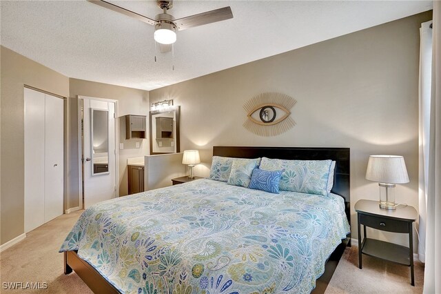 carpeted bedroom with a textured ceiling and ceiling fan