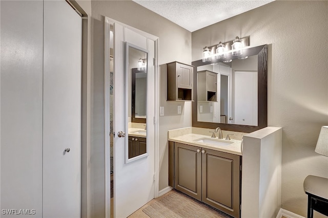 bathroom featuring vanity and a textured ceiling