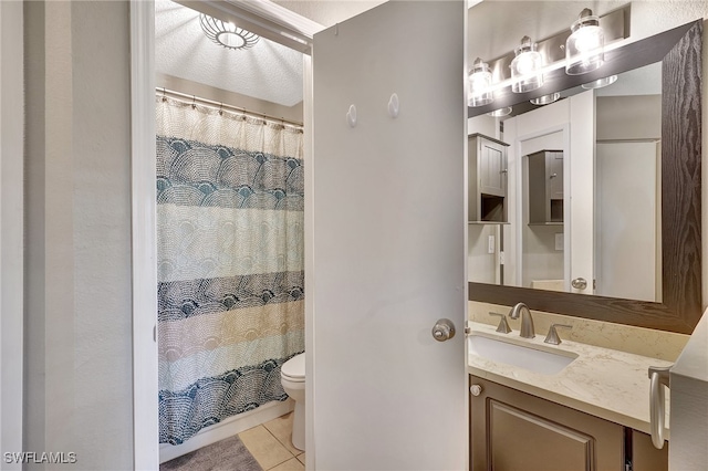 bathroom with tile patterned floors, vanity, toilet, and walk in shower