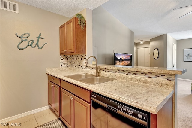 kitchen with dishwasher, sink, kitchen peninsula, a textured ceiling, and decorative backsplash