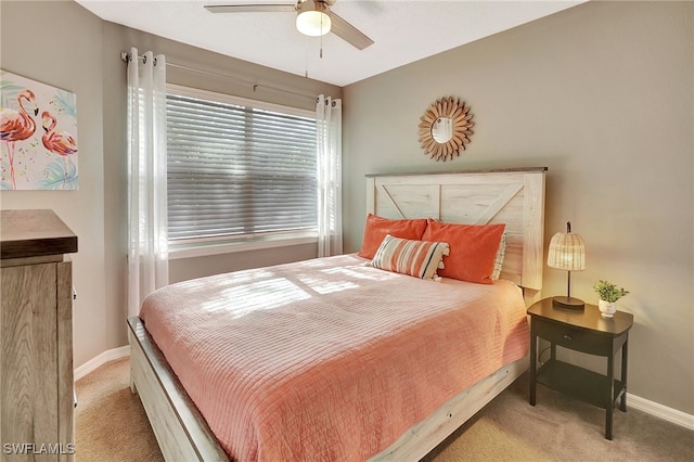 bedroom featuring ceiling fan and light carpet