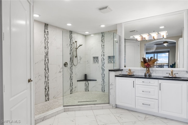 bathroom featuring a tile shower, vanity, and ceiling fan