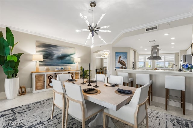 dining room with crown molding and an inviting chandelier