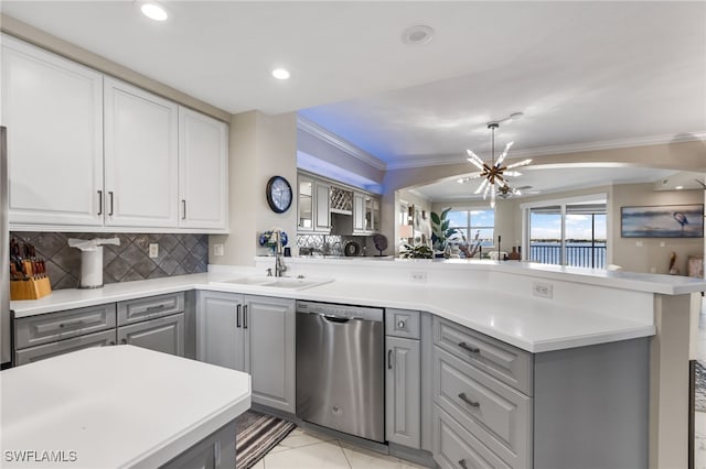 kitchen featuring kitchen peninsula, stainless steel dishwasher, gray cabinetry, sink, and a chandelier