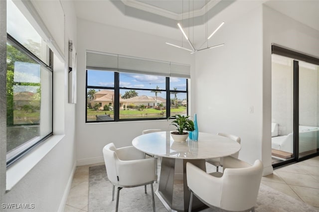 tiled dining area with crown molding, a chandelier, and plenty of natural light