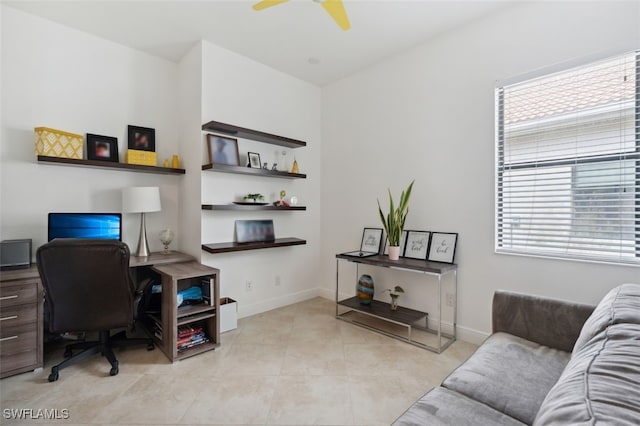 tiled office space featuring ceiling fan