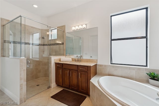 bathroom featuring vanity, shower with separate bathtub, and tile patterned flooring