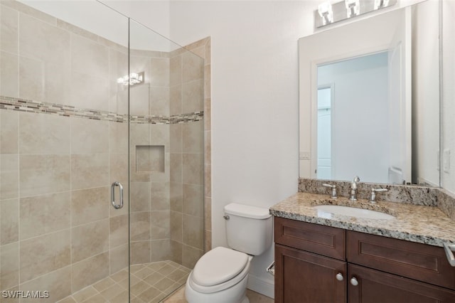 bathroom with vanity, toilet, and an enclosed shower