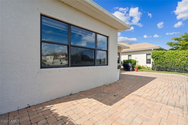 view of side of property with a patio