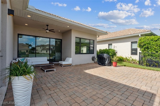 view of patio with area for grilling and ceiling fan