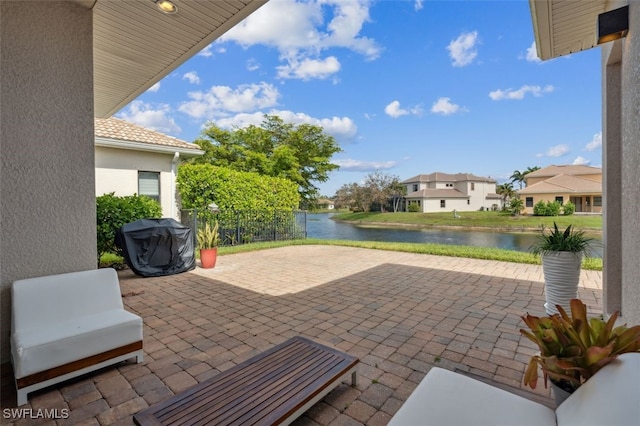 view of patio with a water view and area for grilling