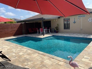 view of swimming pool with a patio