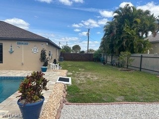 view of yard featuring a fenced in pool and a patio area