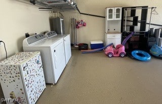 laundry room featuring water heater and washing machine and clothes dryer