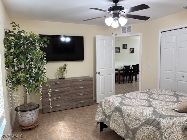 tiled bedroom with a closet and ceiling fan