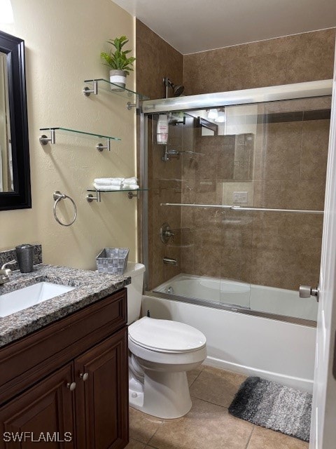 full bathroom featuring vanity, toilet, tile patterned floors, and enclosed tub / shower combo