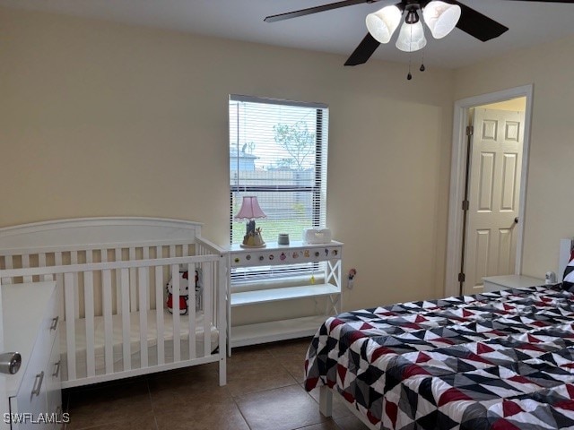 bedroom featuring dark tile patterned flooring and ceiling fan