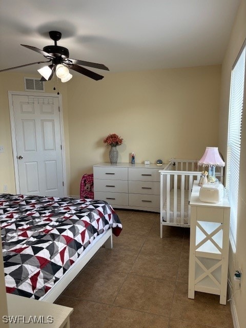 bedroom featuring ceiling fan and dark tile patterned floors