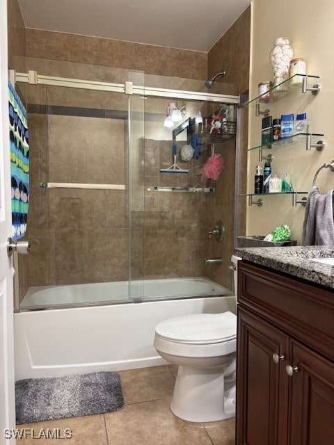 full bathroom with vanity, combined bath / shower with glass door, toilet, and tile patterned flooring