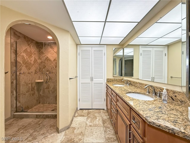 bathroom with vanity and tiled shower