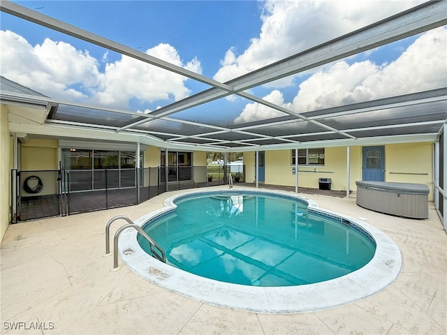 view of pool featuring a patio area and glass enclosure