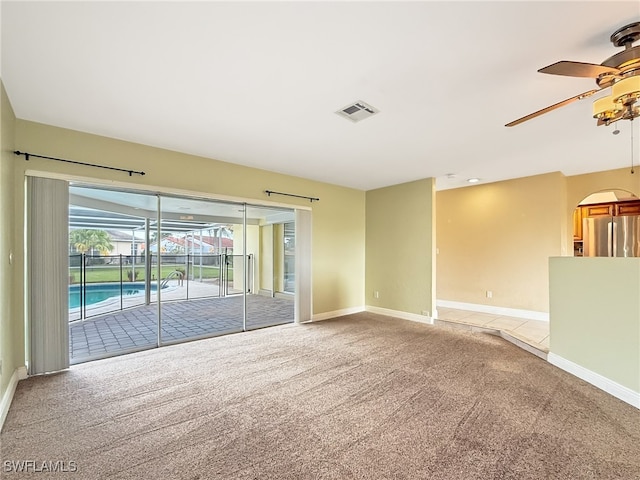 carpeted empty room with ceiling fan