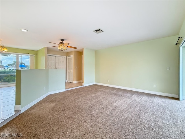 carpeted empty room featuring ceiling fan