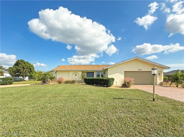 ranch-style house featuring a front lawn and a garage