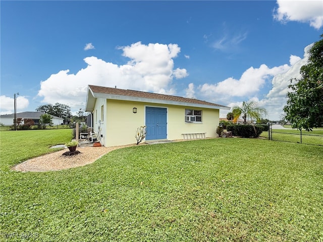 rear view of property with a yard