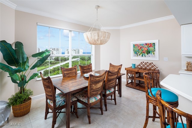 dining room featuring crown molding, a notable chandelier, and light tile patterned floors