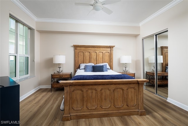 bedroom featuring dark hardwood / wood-style flooring, crown molding, a closet, and ceiling fan