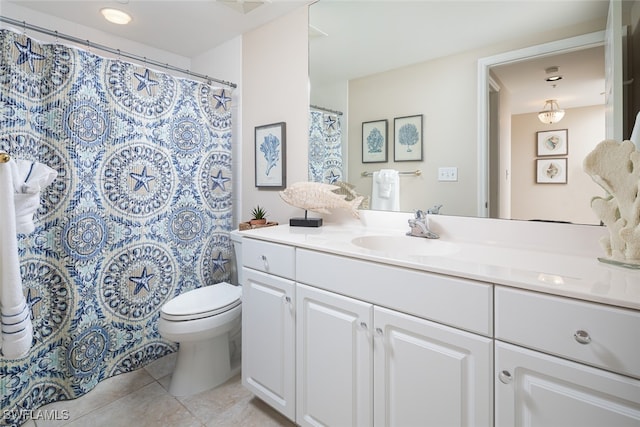 bathroom featuring vanity, toilet, and tile patterned floors