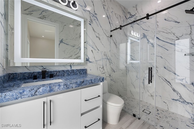 bathroom featuring vanity, toilet, an enclosed shower, and tile walls